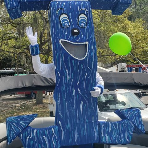 a person standing in front of a blue wall