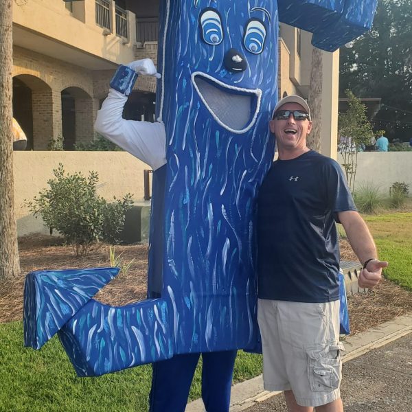 a young boy standing in front of a statue
