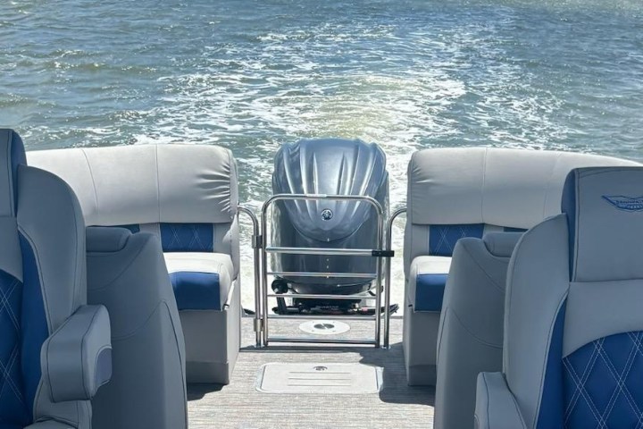 a boat that is sitting on a chair next to a body of water