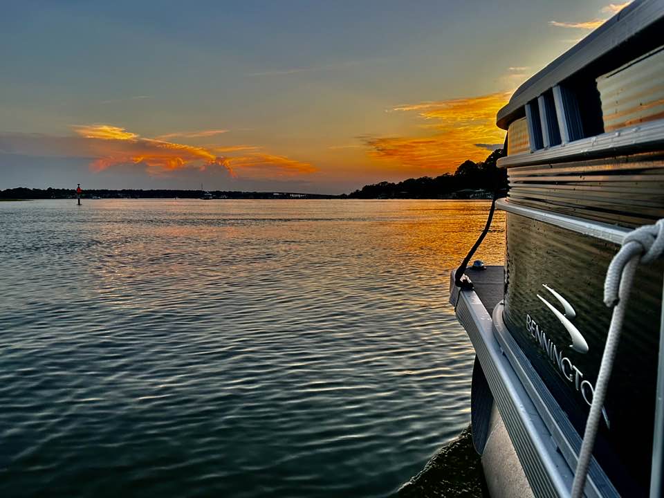 hhi sunset a small boat in a body of water