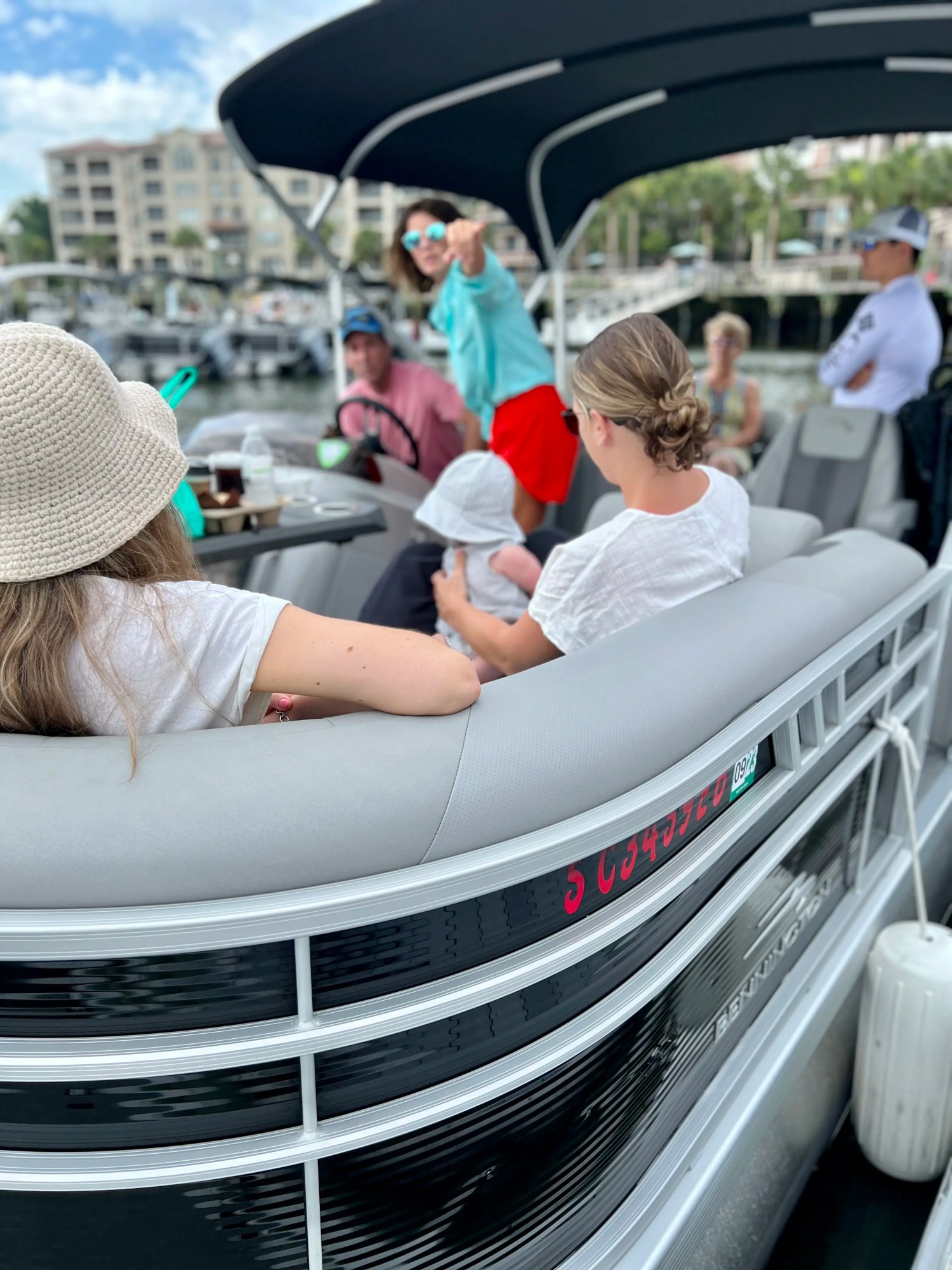 a group of people sitting around a car