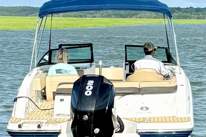 a group of people in a boat on a body of water