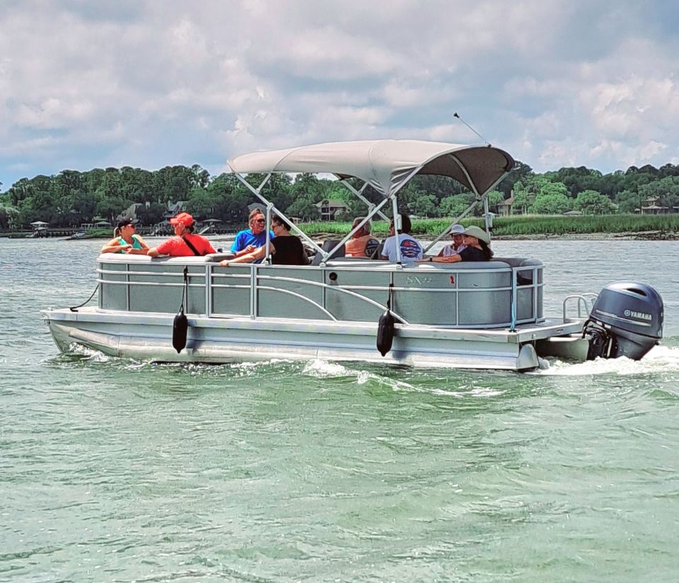 a group of people in a small boat in a body of water