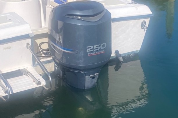 Yamaha 250 outboard motor attached to a boat over calm water.